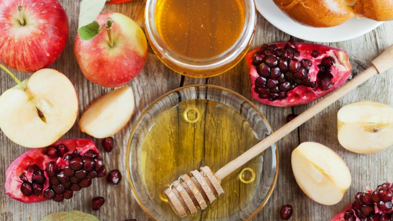 Rosh Hashana, Jewish New Year Holiday, Honey, apple, pomegranate, hala on a wooden table