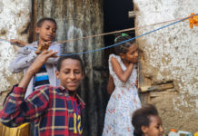 Falash Mura children help hang the washing outside their home in Gondar, Ethiopia, May 29, 2022.