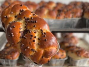 Photo of a braided challah loaf topped with mini chocolate chips.