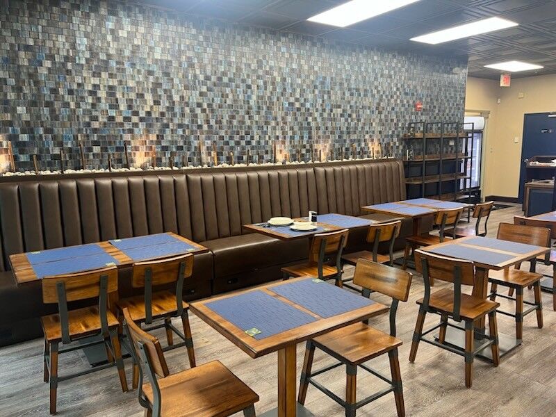 Photo of the interior of a cafe with small tables and chairs.