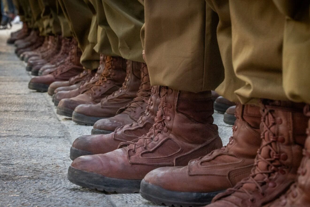 Close-up photo of soldiers' identical brown military boots and brown khakis