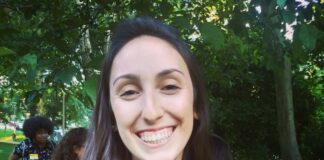 Photo of a young woman with long straight brown hair smiling at the camera.