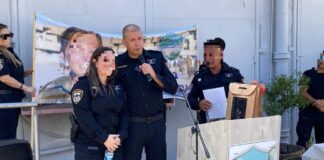 Several people standing behind a podium.