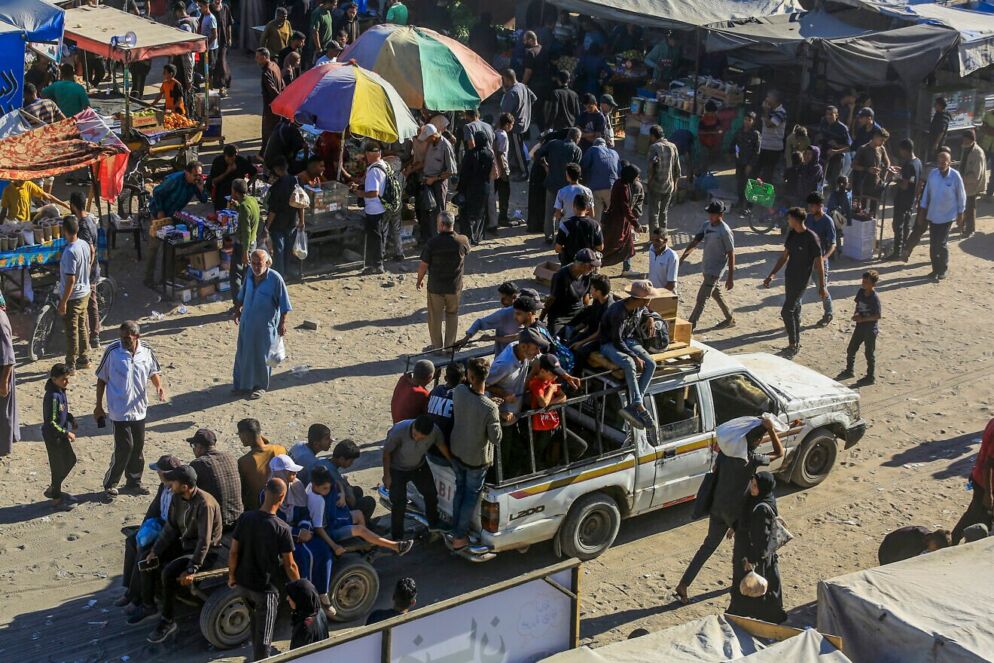 A white pickup truck and people walking outside.