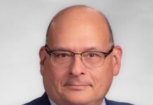 DC DSA Under Fire for ‘Anti-Jewish Loyalty Oath’ in Questionnaire A man wearing glasses, a yellow tie and blue suit jacket.