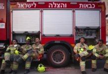 Emergency responders sitting in front of a red truck.