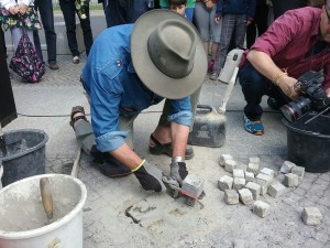 Artist Gunter Demnig installs a Stolperstein, or “Stumbling Stone” in front of the  lawn in Berlin where the house of Holocaust victims Hans and Ruth Gosler once stood. Photo by David Holzel
