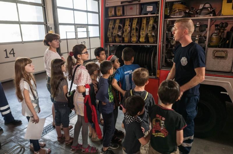 A Berlin firefighter spoke to young refugees during the children’s visit this month to the fire station.Photo by Judith Kessler/JTA 