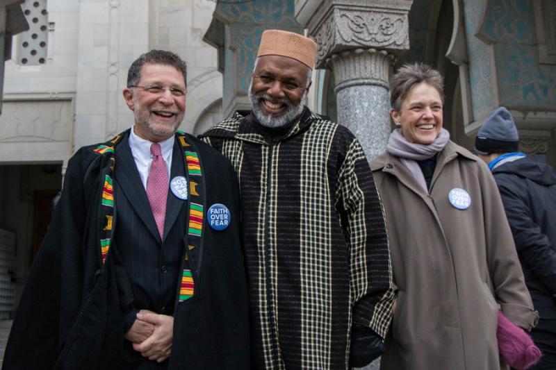 Imam Johari Abdul-Malik, center, literally gave the coat off of his back to Rabbi Bruce Lustig. Also pictured is Bishop Mariann Edgar Budde, Photos by Justin Katz