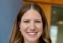 Photo of a young woman with long light brown hair. She is smiling at the camera.