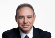 DC Mayoral Candidate Seeks to Embody Tikkun Olam Headshot of a man with short hair and a black suit and tie with his hands gently crossed in front of him.