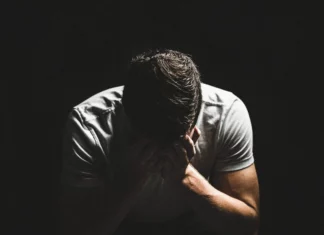 Opinion: Unmasking Israel’s Mental Health Crisis A man with his head in his hands.