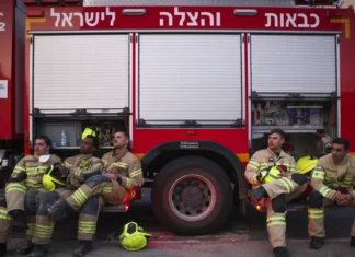 Opinion: The Ceasefire Gambit Emergency responders sitting in front of a red truck.