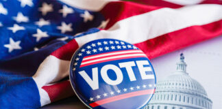 A "vote" button in front of an American flag and the U.S. Capitol.